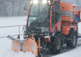 Road salt: Snowplow spreading road salt during a winter storm.