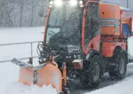 Road salt: Snowplow spreading road salt during a winter storm.