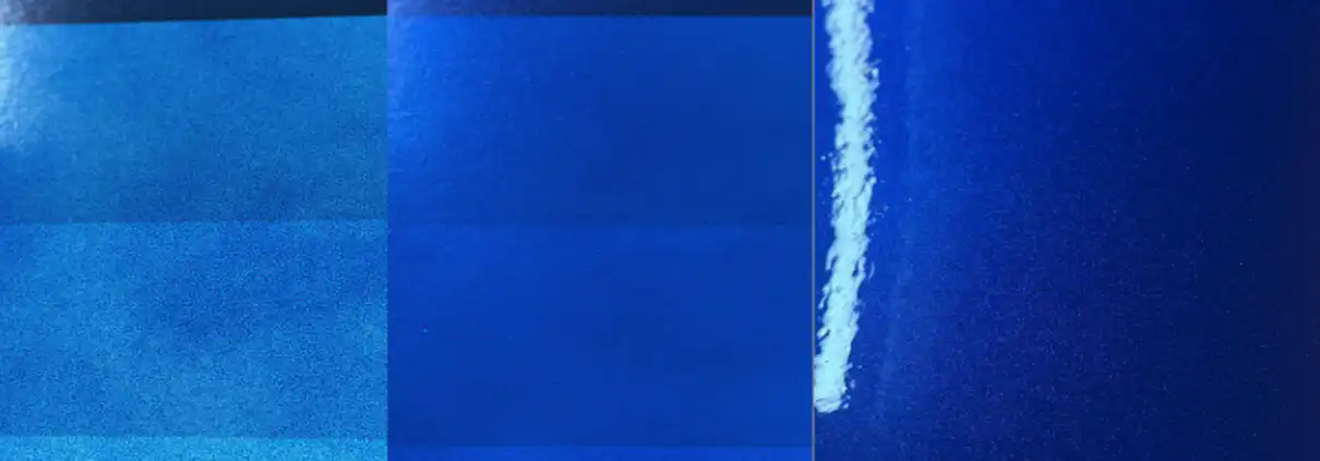 Spray-out panels show why blue needs more coats: the first layers look light and thin, but as coats build, the color deepens into a vivid, glowing blue.