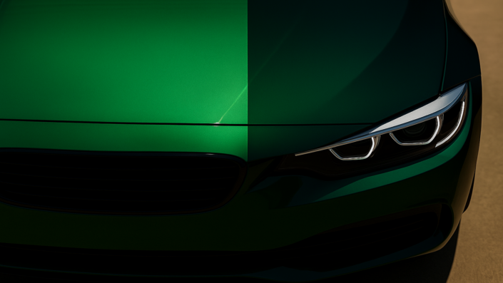 Close-up of a green sports car hood showing a split between sunlight and shadow, illustrating how green automotive paint shifts from vivid emerald in bright light to nearly black in shade.